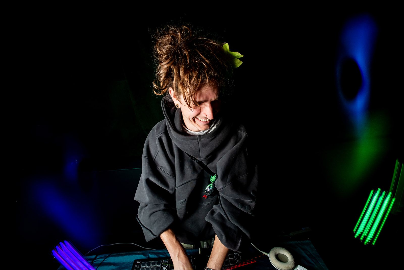 SNUGG behind the decks under colored stage lights