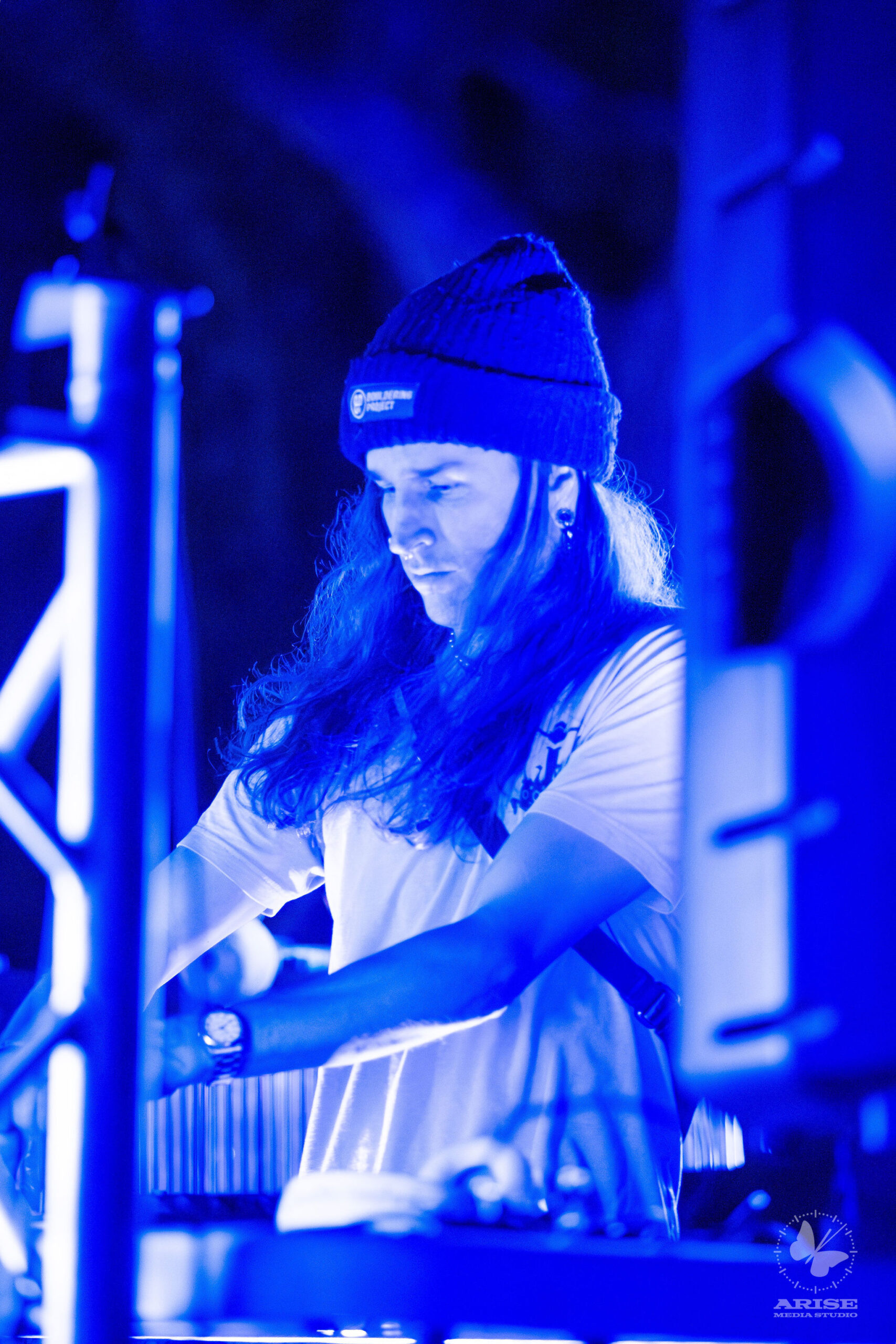 SNUGG performing live under blue stage lighting